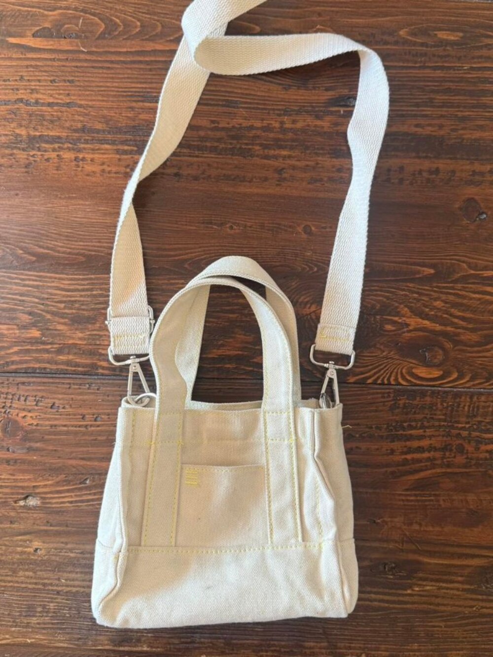 urban outfitters Cream canvas mini tote bag with yellow stitching   has some